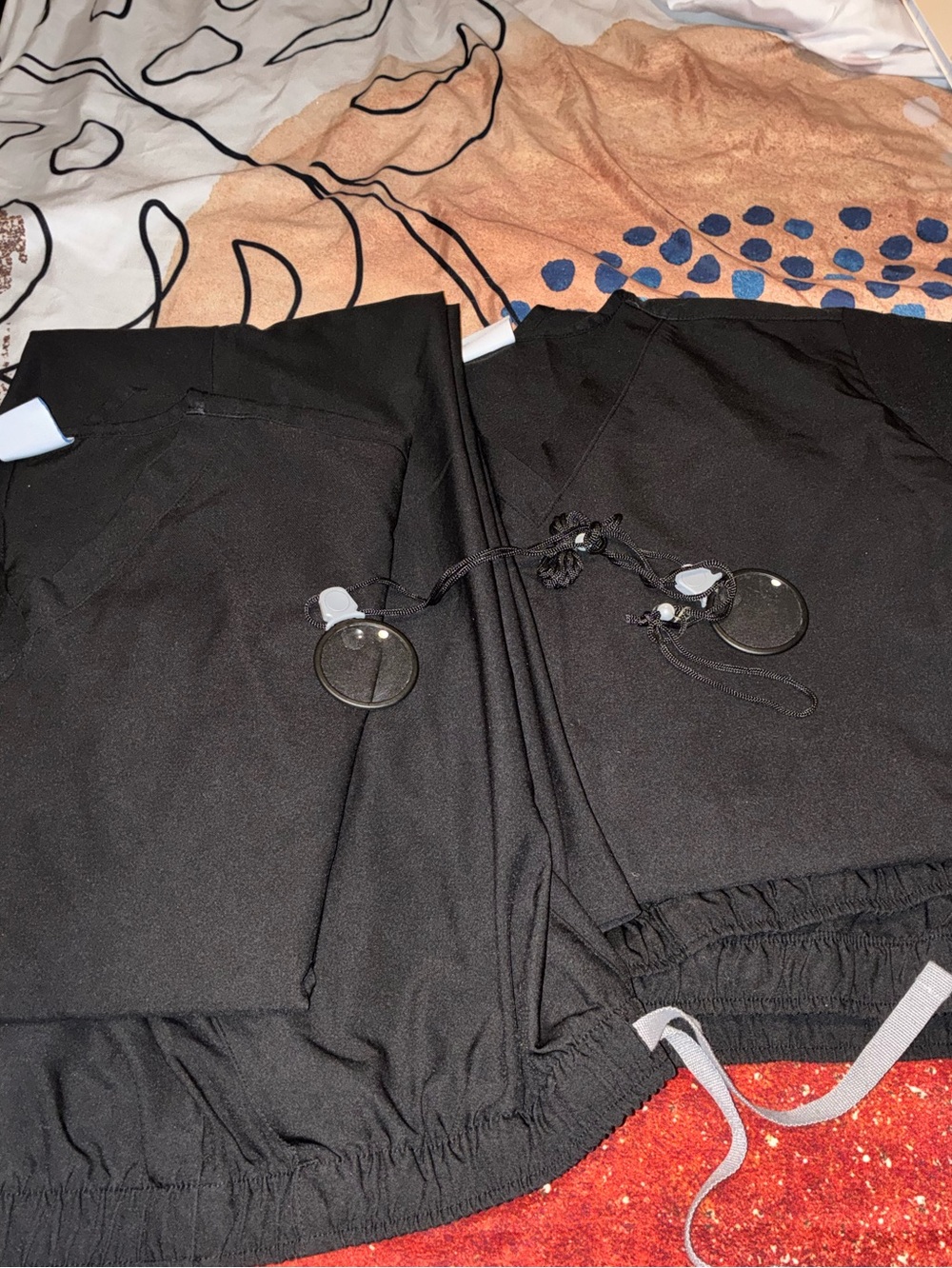 Two Pair Of Black Scrubs Pants and Tops and two pair of magnifying glasses
